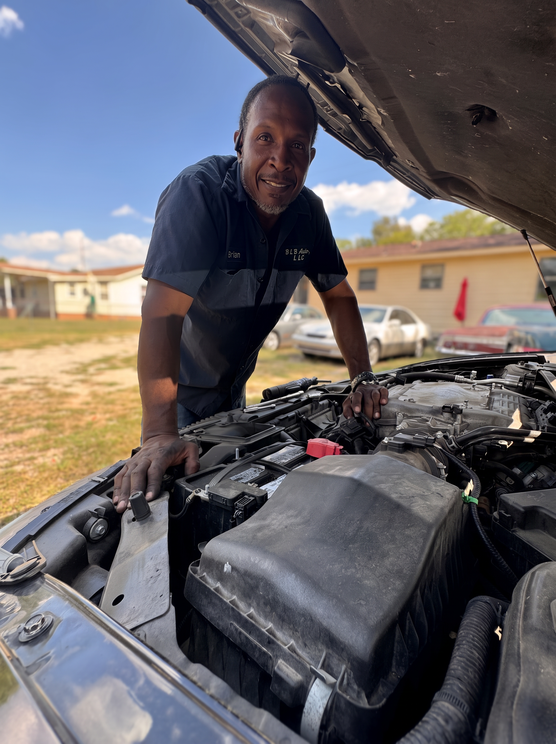 Brian of BLB Auto, LLC working under the hood of a car